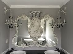 a bathroom with two sinks and a mirror on the wall above it's mirrors