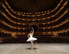 a ballerina is standing in front of an empty stage