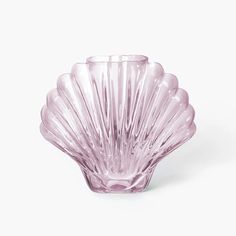 a pink glass vase sitting on top of a white table