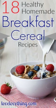 breakfast cereal is being poured into a bowl with berries and milk on the table next to it