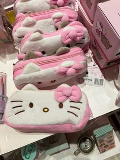 several hello kitty purses on display in a store