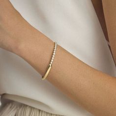 Our first bangle bracelet ever created, we imagined the Unico bracelet with the glamour of celebration in mind. This exceptional piece will be your go-to for those spotlight moments when you need some extra shine. Timeless Bangle Tennis Bracelet, Yellow Gold Bangle Jewelry For Party, Yellow Gold Bangle For Party, Modern White Gold Bracelets For Anniversary, Timeless White Gold Bangle Bracelets, Elegant Party Tennis Bracelet Bangle, Elegant Brilliant Cut Bangle, Modern Jubilee Tennis Bracelet For Party, Timeless Bangle Bracelets For Party