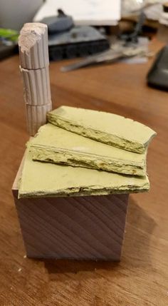 three pieces of cake sitting on top of a wooden table next to a computer keyboard