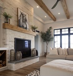 a living room with a couch, fireplace and tv in it's centerpiece