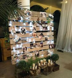 a wooden pallet with candles and pictures on it