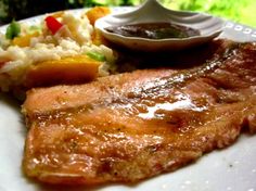 a white plate topped with meat and vegetables