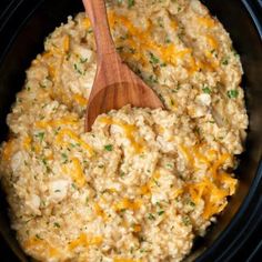 a crock pot filled with rice and cheese