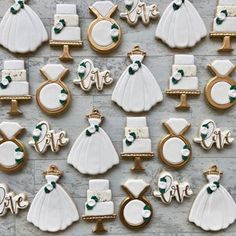 decorated wedding cookies are arranged on a table