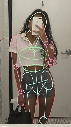 a woman taking a selfie in front of a mirror with neon lines on it