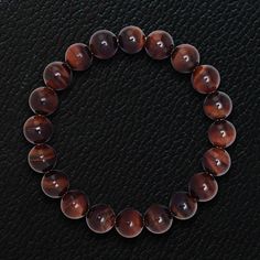 Our spiritual Himalayan Beads bracelets are meticulously handcrafted using high grade certified natural gemstones. Meaningful and healing, powers of our precious and semi-precious gemstones are enhanced by a purification process to maximize their spiritual powers. Discover unique mens designs in powerful gemstones for an immediately uplifting statement of spirits and style. Iron Tiger Eye beads, 10mm Stretch Bracelet Sleek gift box included Iron Tiger Eye is a stone of strength, stamina and cour Brown Crystal Bracelet With Gemstone Beads, Brown Gemstone Bracelets, Brown Gemstone Round Bracelets, Beaded Bracelet For Men, Gemstones And Crystals, Spiritual Symbols, Spiritual Power, Red Tigers Eye, Beads Bracelets