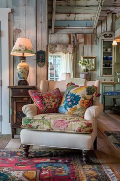 a living room filled with furniture and lots of pillows