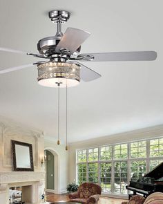 a living room with a piano and chandelier hanging from the ceiling above it