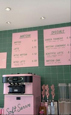 the menus on the wall are pink and green, with black lettering that reads matcha