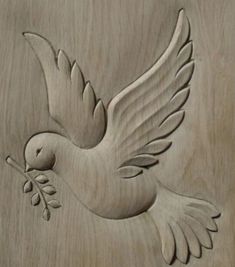 a carved dove with an olive branch in its beak