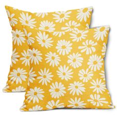 two yellow pillows with white daisies on the front and back, one is made out of