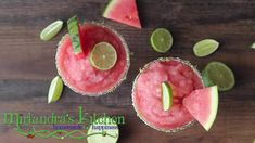 two glasses filled with watermelon and limeade on top of a wooden table