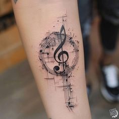 a music note tattoo on the arm with musical notes and trebles in it