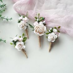 three small flowers are placed on top of each other in the shape of twig