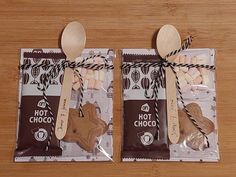 two bags of hot chocolate with wooden spoons