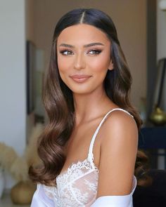 a woman with long hair wearing a white dress