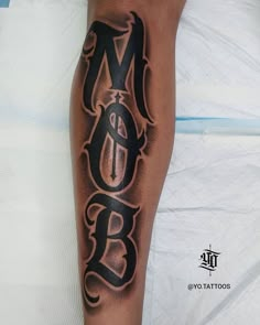 a man with a tattoo on his leg that says b o b and has an arrow in the middle