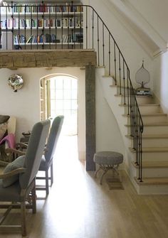 a living room filled with furniture next to a stair case