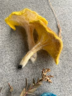 the needle is hooked up to an orange flower and some other things are laying on the floor