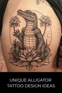 an alligator tattoo design on the back of a woman's thigh, with flowers and leaves around it