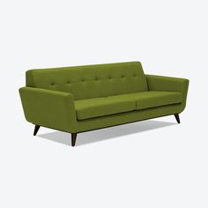 a green couch sitting on top of a white floor