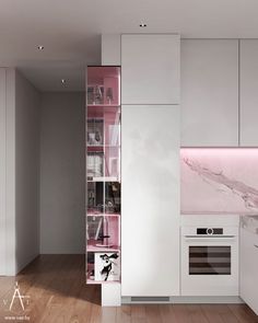 a white kitchen with pink accents and marble backsplashes on the wall, along with wooden floors