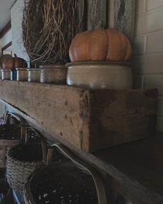 an old fireplace mantel with baskets and pumpkins on top