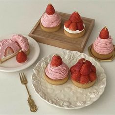 there are three desserts with strawberries on top