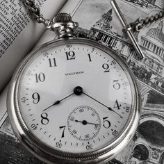 an old pocket watch sitting on top of a book