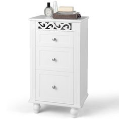 a white cabinet with drawers and some items on top of it, in front of a white background