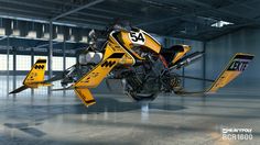 a yellow and black motorcycle parked in an empty warehouse with its wheels still on the ground