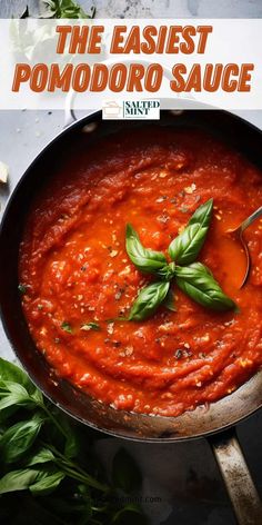 the best pomodoro sauce in a skillet with basil leaves on top