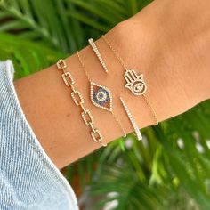 14K Gold Diamond Evil Eye Hamsa Bracelet. Hamsa symbolize good fortune, health and happiness. This cute bracelet shine on its own or stacked with different styles. Item Information: Metal: 14k Gold Weight: 1.7g Chain Length: 6" + 1" Extender Dimensions: 10.25x13.75mm Diamond Information: No. of Diamonds: 72 Total Carat Weight: 0.16 Turquoise Heart Necklace, Evil Eye Hamsa, Pave Diamond Earrings, Hamsa Bracelet, Diamond Evil Eye, Turquoise Heart, Mother Of Pearl Necklace, Bee Necklace, Small Charms