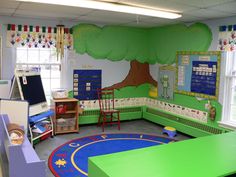 a classroom with green walls and blue carpet