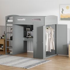 a loft bed with a desk and closet in the corner, next to a rug