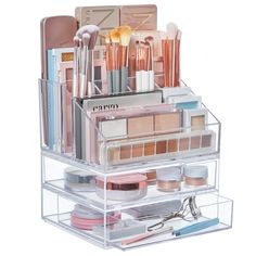 a clear container with makeup and other items in it