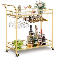 a gold bar cart with wine glasses and bottles