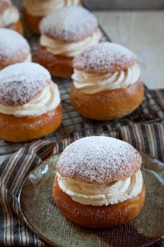 several pastries sitting on top of a plate covered in powdered doughnuts