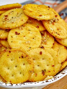 a white bowl filled with crackers on top of a wooden table