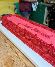 a large red cake sitting on top of a table