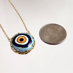 Introducing our stunning Cable Chain with a Hand-Painted 19mm Evil Eye Turkish Pendant in a Decorative Prong Setting. This gold Evil Eye Necklace is the perfect addition to any jewelry collection, with its unique design and intricate detailing. Crafted with care, this necklace features an 18+2 inch chain and a hand-painted Turkish pendant measuring 19mm in size. The evil eye symbol is said to ward off negative energy and bring good luck, making this necklace both beautiful and meaningful. Our Ca Gold Evil Eye Necklace, Ward Off Negative Energy, Evil Eye Symbol, Evil Eye Necklace Gold, Eye Symbol, Hand Painted Ceramic, The Evil Eye, Evil Eye Necklace, Eye Necklace