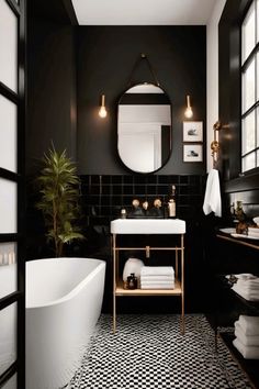 a black and white bathroom with a bathtub, sink, mirror and potted plant