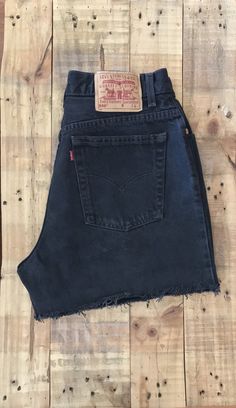 "High waisted 90's denim shorts. Made by Levi's in classic black denim wash. Shorts are in excellent clean condition. Perfectly worn in with light naturally distressed character. These have been cut off and washed once. Measurements are taken zipped or buttoned up and laid comfortably flat then x 2 for total circumference (inches) Tag Size 14 Reg Levis 550 100% Cotton ~Measure Rise First~ Waist 31\" Hips 44\" Length 15\" Inseam 4\" Rise 12\" leg opening circumference 25\" All items are free of r Retro Cutoff Jean Shorts For Streetwear, 90s Style Cutoff Bottoms For Streetwear, Grunge Cutoff Jean Shorts For Streetwear, 90s Style Frayed Hem Cutoff Jean Shorts, Fitted Cutoff Shorts For Streetwear, 90s Style High Rise Dark Wash Jean Shorts, 90s High Waist Shorts For Streetwear, 90s High Rise Dark Wash Jean Shorts, 90s Style Jean Shorts With Frayed Hem