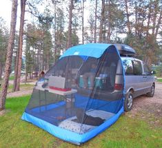 a tent set up in the woods with people inside