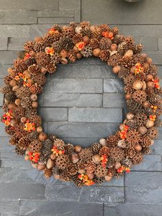 a wreath made out of pine cones and acorns