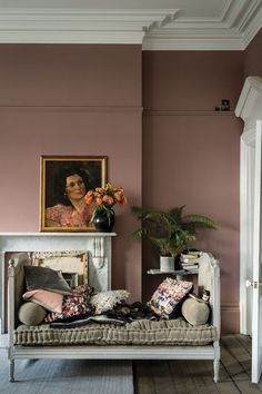 a living room filled with furniture and a painting on the wall